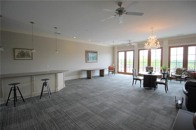 interior space featuring a healthy amount of sunlight, ornamental molding, and dark colored carpet