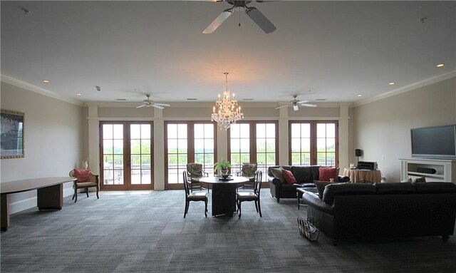 carpeted living room with crown molding and ceiling fan with notable chandelier