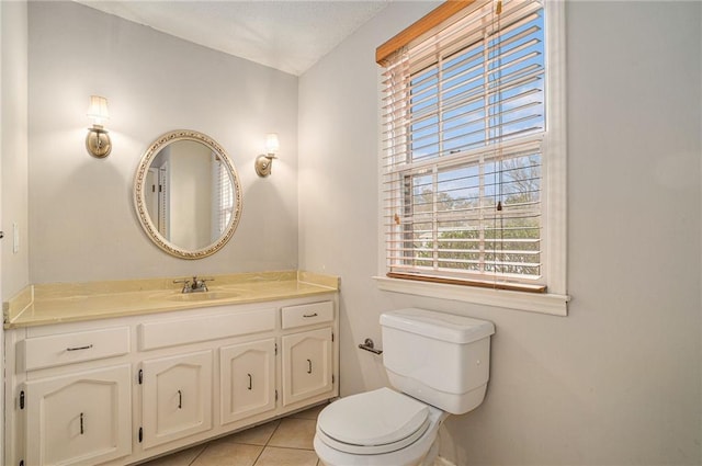 bathroom featuring tile patterned flooring, vanity, and toilet