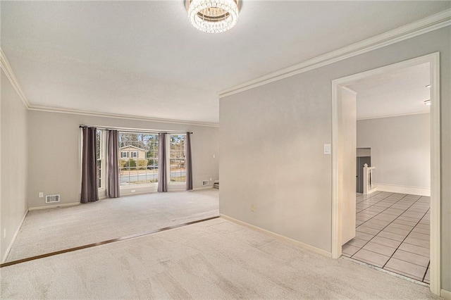 carpeted empty room featuring crown molding