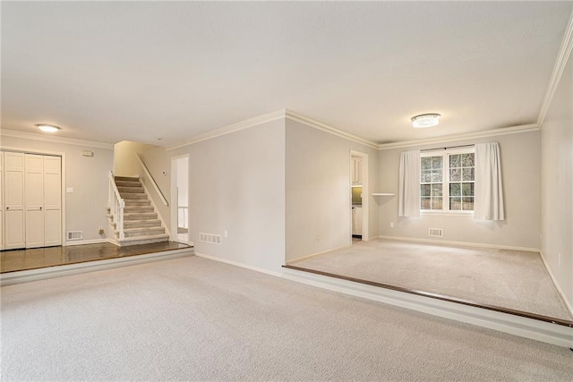 spare room featuring crown molding and carpet floors