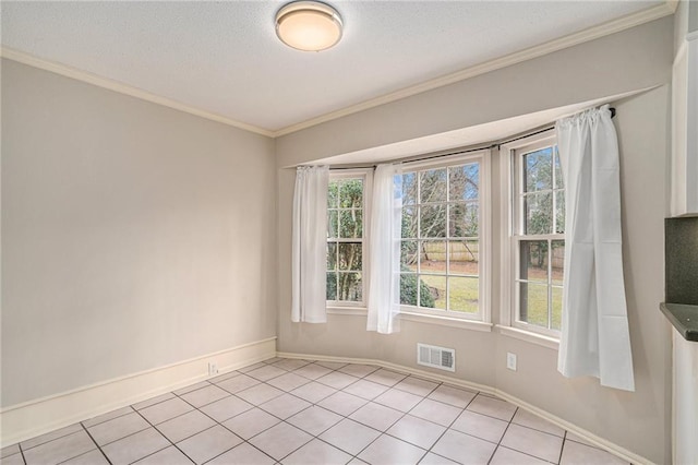 tiled spare room featuring crown molding