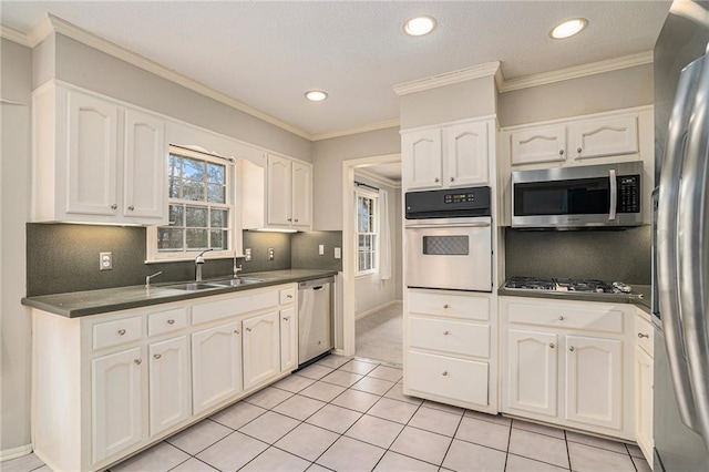 kitchen featuring white cabinetry, appliances with stainless steel finishes, sink, and decorative backsplash