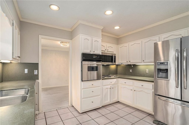 kitchen featuring light tile patterned floors, backsplash, white cabinets, and appliances with stainless steel finishes