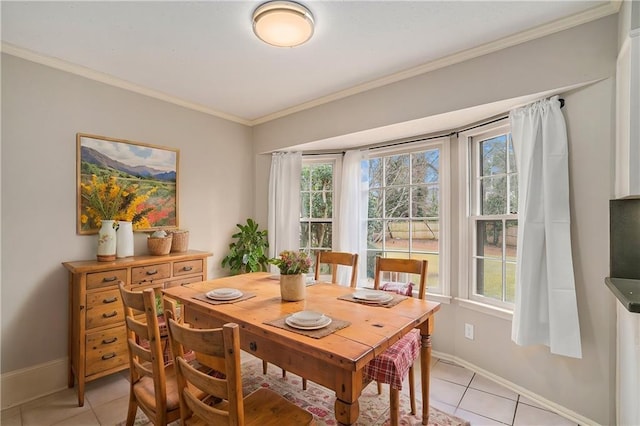 tiled dining space with a wealth of natural light and ornamental molding