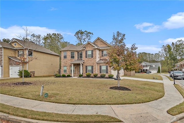 view of front of house featuring a garage and a front lawn