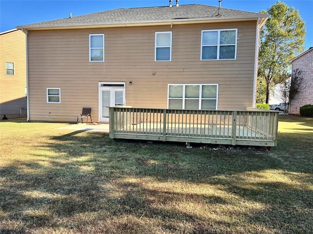 back of house featuring a wooden deck and a lawn