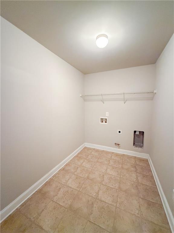 laundry area with hookup for a gas dryer, hookup for a washing machine, and hookup for an electric dryer