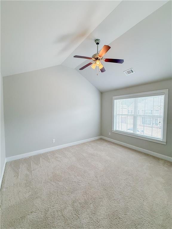 spare room with lofted ceiling, light carpet, and ceiling fan