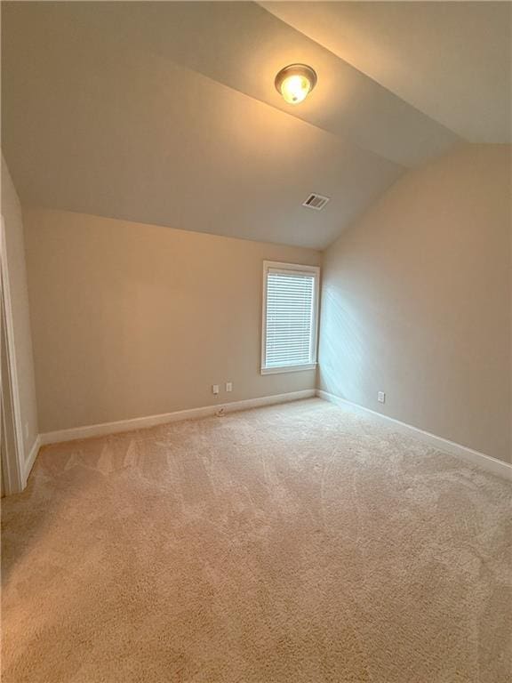 bonus room with carpet floors and vaulted ceiling