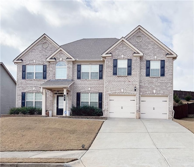 view of front of house with a garage and a front yard