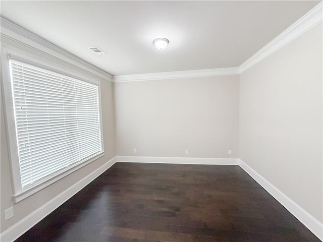 empty room with crown molding and dark hardwood / wood-style floors