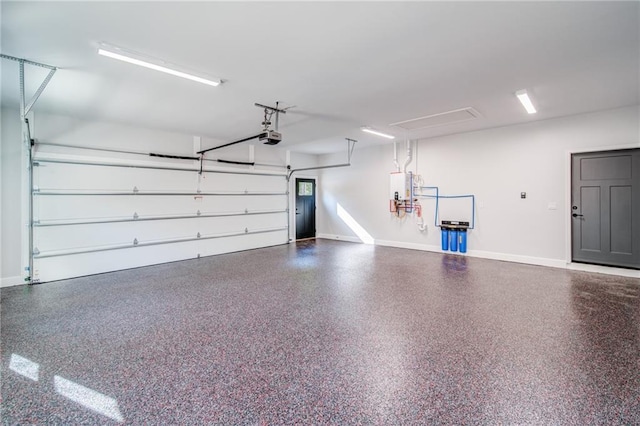 garage with baseboards and a garage door opener