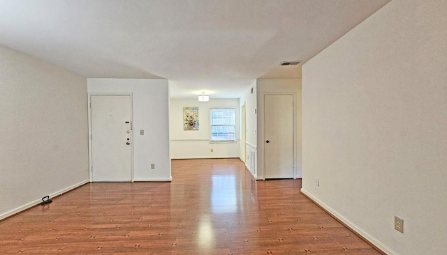 empty room with light hardwood / wood-style flooring