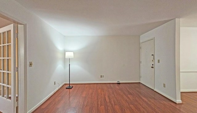 spare room featuring wood-type flooring