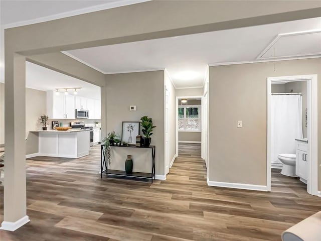 hall featuring hardwood / wood-style floors and crown molding