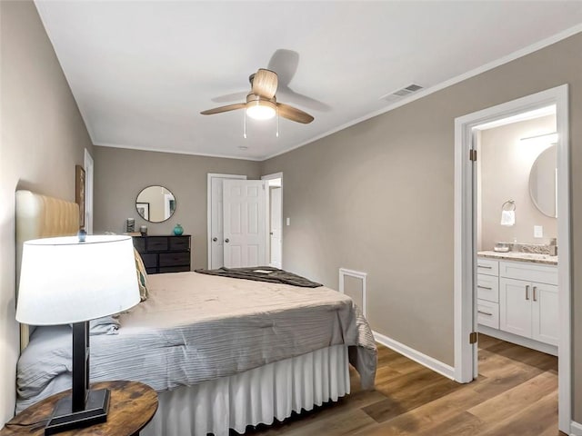 bedroom with ensuite bath, sink, hardwood / wood-style flooring, ceiling fan, and crown molding