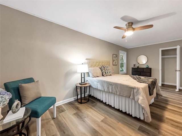 bedroom featuring ceiling fan, crown molding, and hardwood / wood-style flooring