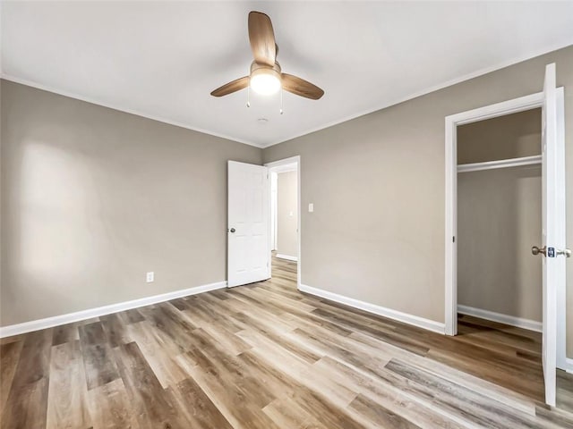 unfurnished bedroom featuring ceiling fan, a closet, and light hardwood / wood-style flooring