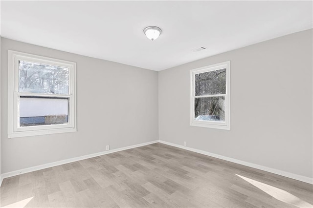 spare room featuring light hardwood / wood-style flooring