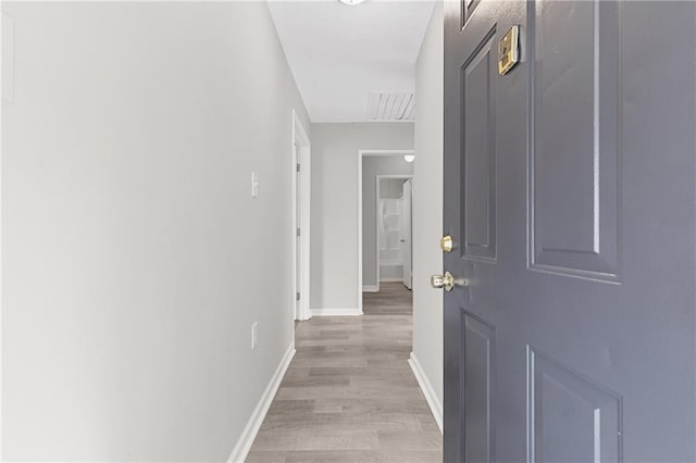 corridor with light wood-type flooring