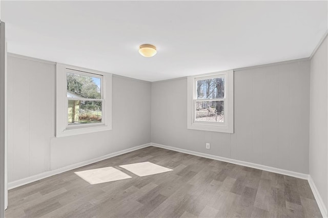 empty room with light hardwood / wood-style flooring