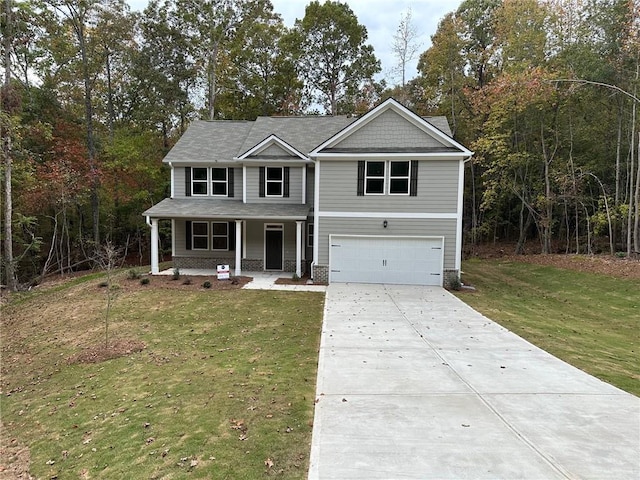 view of front of home with a garage, covered porch, and a front lawn