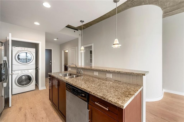 855 Peachtree St NE Unit 3205, Atlanta, GA 30308 - kitchen with dishwasher, stacked washing machine and dryer, a sink, light wood-style flooring, and baseboards