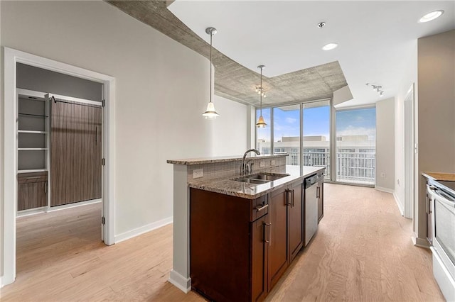 855 Peachtree St NE Unit 3205, Atlanta, GA 30308 - kitchen with a sink, light wood-type flooring, baseboards, and dark brown cabinetry
