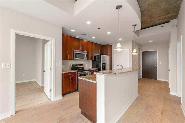 855 Peachtree St NE Unit 3205, Atlanta, GA 30308 - kitchen with appliances with stainless steel finishes, light wood-type flooring, light stone counters, decorative light fixtures, and recessed lighting