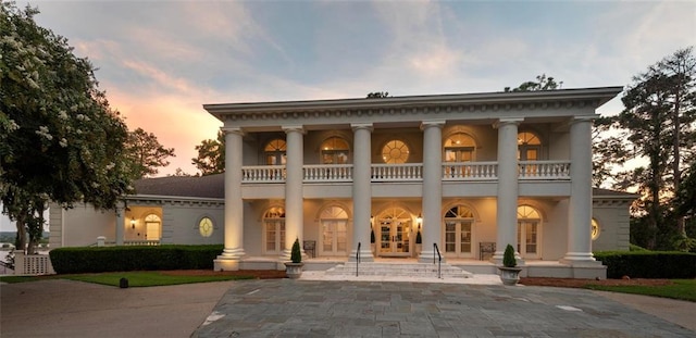 neoclassical / greek revival house with french doors and a balcony