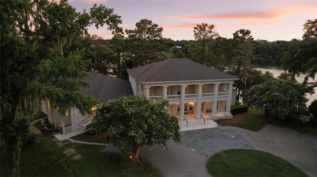 back house at dusk with a patio area