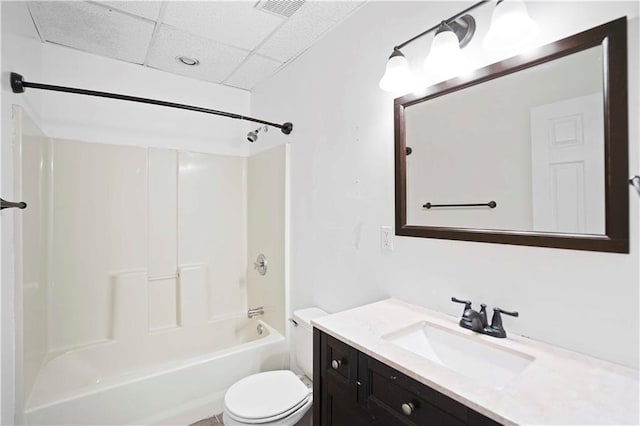 full bathroom with vanity, washtub / shower combination, visible vents, a paneled ceiling, and toilet