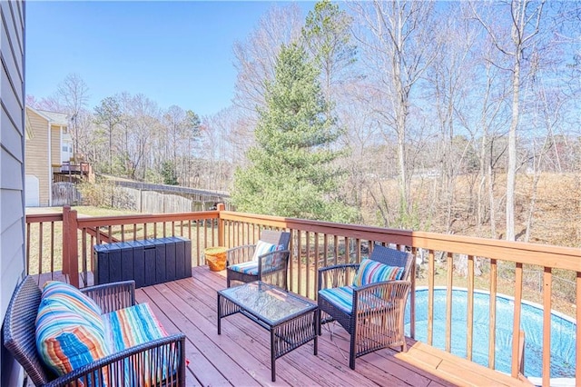 deck with an outdoor pool and an outdoor hangout area