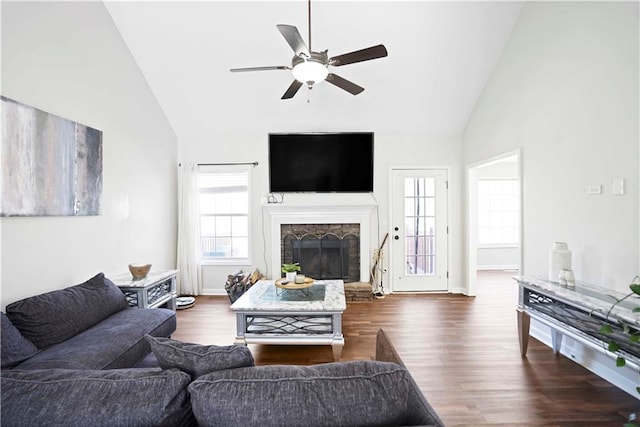 living room with high vaulted ceiling, a ceiling fan, wood finished floors, a fireplace, and baseboards