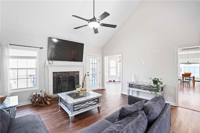 living room with a healthy amount of sunlight, wood finished floors, and a fireplace