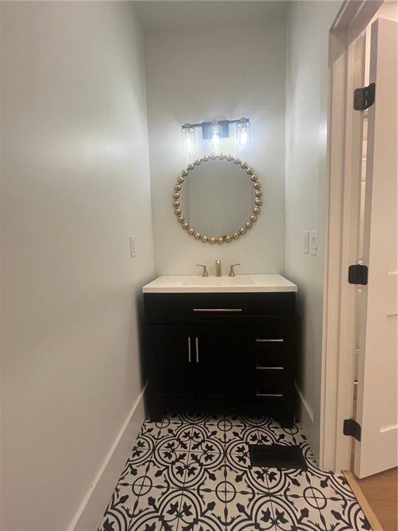 bathroom featuring baseboards, vanity, and tile patterned floors