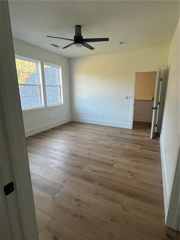 unfurnished bedroom with baseboards, visible vents, and light wood-style floors