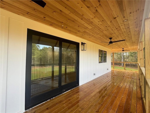 wooden deck featuring a ceiling fan