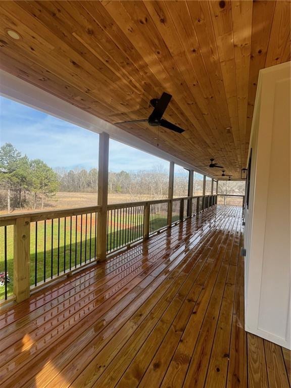 wooden deck with a ceiling fan