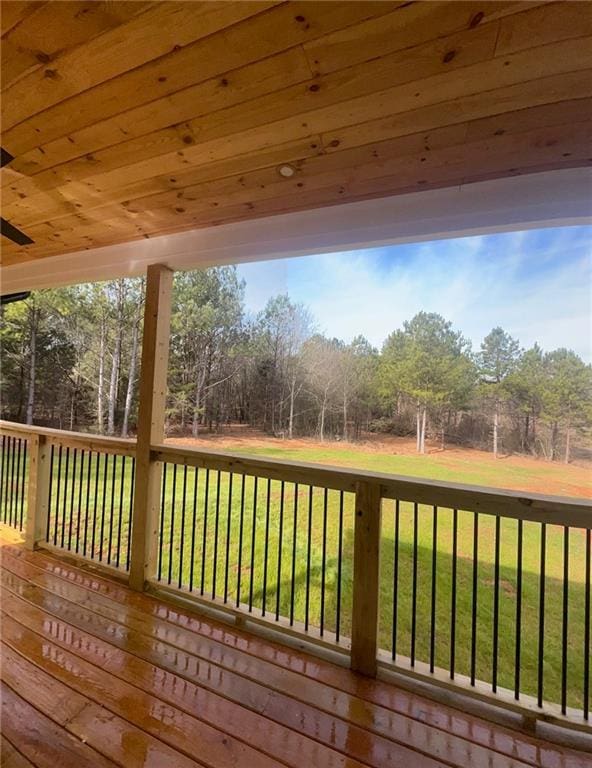 wooden terrace with a lawn