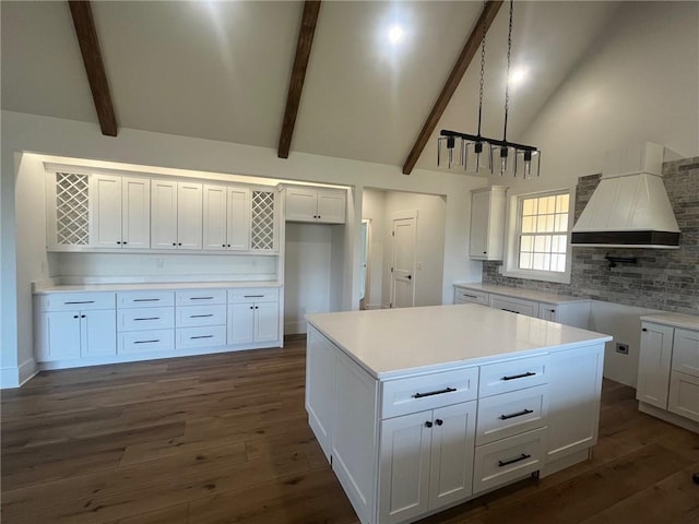 kitchen with white cabinets, light countertops, and decorative light fixtures