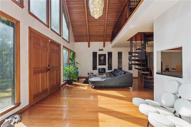 foyer featuring wood ceiling, a chandelier, hardwood / wood-style flooring, beam ceiling, and high vaulted ceiling