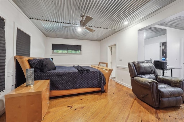 bedroom with ceiling fan and light hardwood / wood-style flooring