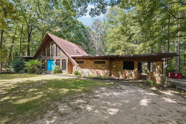 view of front of house with a front yard and a carport