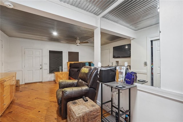 sitting room with light hardwood / wood-style flooring and ceiling fan