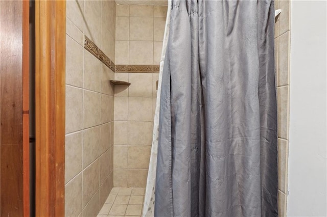 bathroom featuring walk in shower and tile patterned flooring