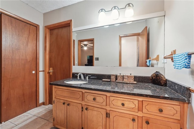 bathroom featuring a textured ceiling, tile patterned flooring, vanity, and ceiling fan