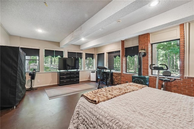 bedroom featuring a wood stove, a textured ceiling, and beamed ceiling