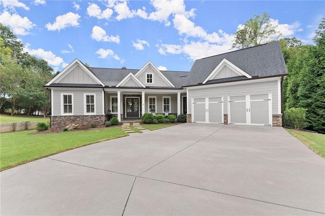 craftsman house featuring a porch, a garage, and a front yard